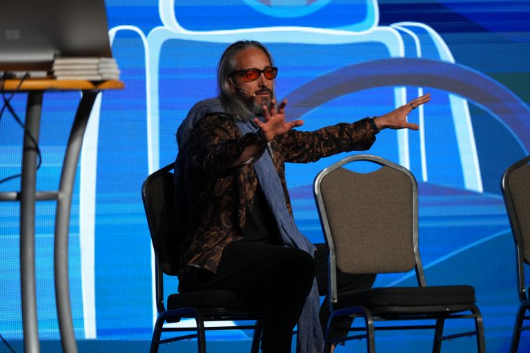 Garrett Gunderson in futuristic outfit on stage at an event