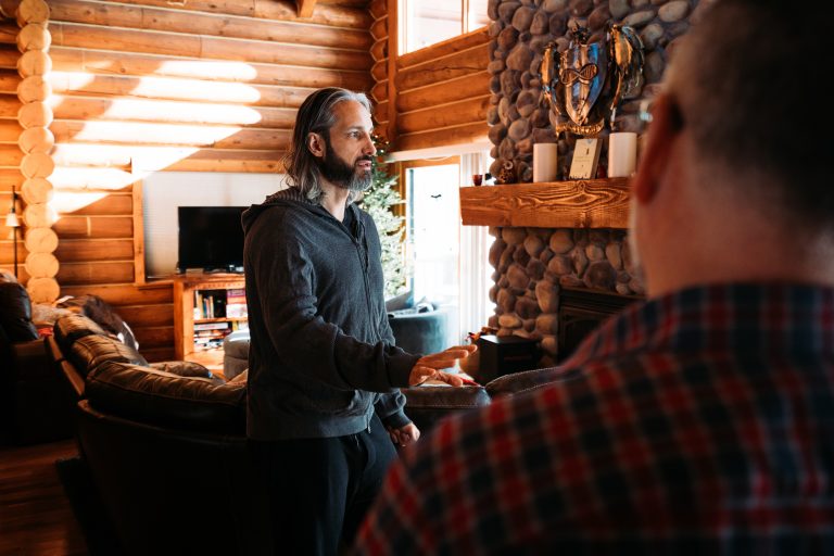 Garrett Gunderson teaching wealth-building principles in rustic cabin setting