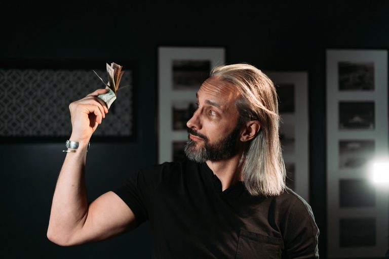 Garrett Gunderson holding cash in his office