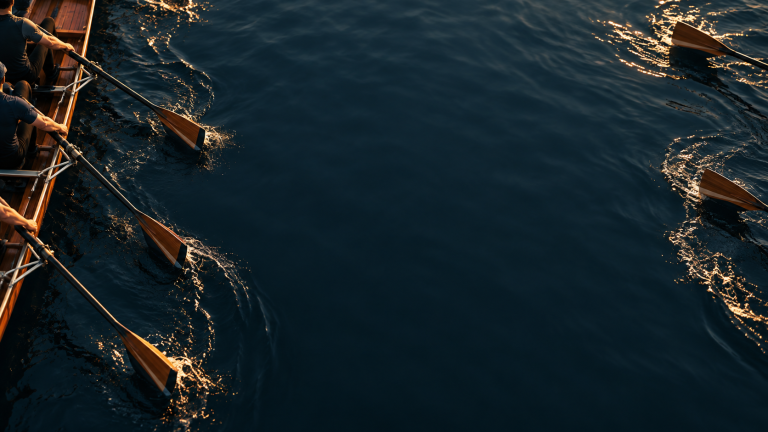 Rowers working together across dark water